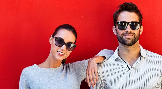 Man and woman in sunglasses smiling