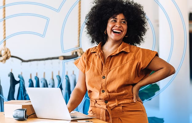 Fashion retailer in stylish workspace using laptop